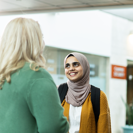 Student smiling while talking to Instructor Emily McNair